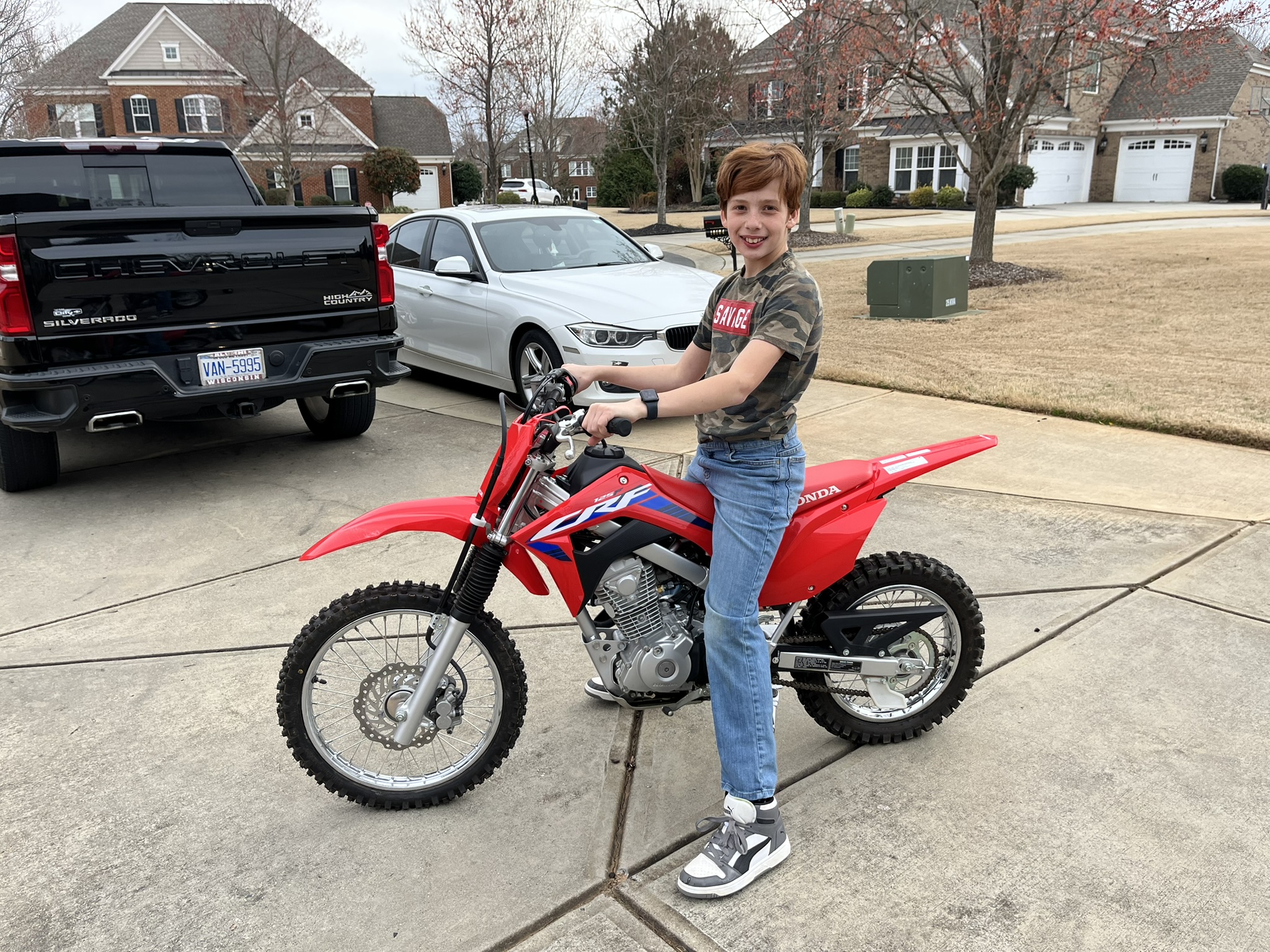 Michael helmeted on Honda in field